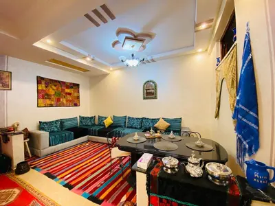 a living room with a couch and a table at Cozy Moroccan-style apartment in Marrakech