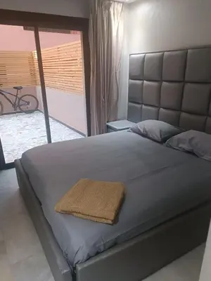 a large bed with a large headboard in a bedroom at Modern apartment in the Heart of the City in Marrakech