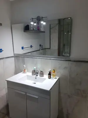 a bathroom with a sink and a mirror at Modern apartment in the Heart of the City in Marrakech