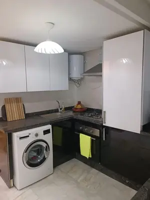 a kitchen with a washer and a washing machine at Modern apartment in the Heart of the City in Marrakech