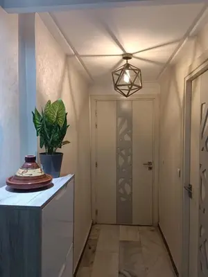a hallway with a door and a potted plant at Modern apartment in the Heart of the City in Marrakech