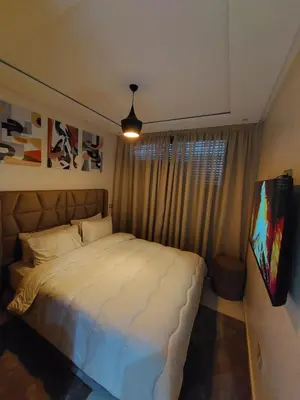 a bedroom with a large white bed and a window at Appartement centre ville marrakech in Marrakech