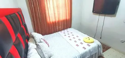 a small room with a bed with a yellow object on it at Do7a Marrakech in Marrakech