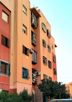 a tall building with balconies on the side of it at Do7a Marrakech in Marrakech