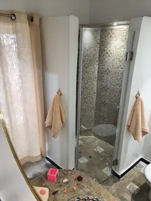 a bathroom with a shower with a glass door at Dar Le Monde in Marrakech