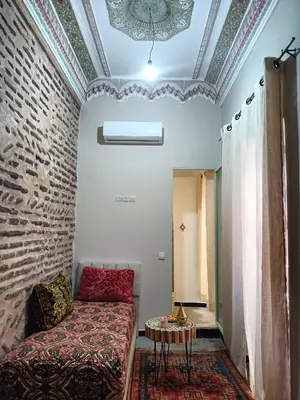 a room with a bed and a table in it at Dar Le Monde in Marrakech