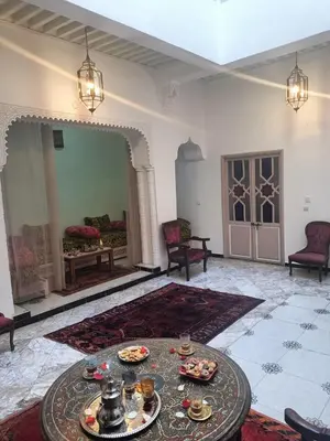 a living room with a table with food on it at Dar Le Monde in Marrakech