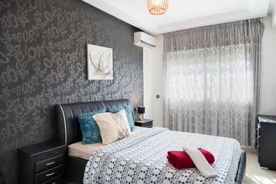 a bedroom with a bed with red pillows on it at حي الشرف in Marrakech