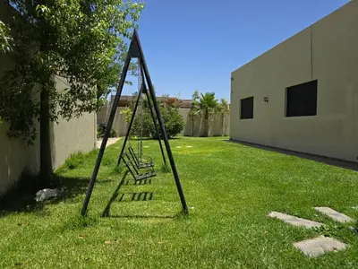 a swing in the grass in a yard at Villa echwitter in Marrakech