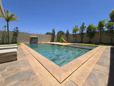 a swimming pool in the middle of a yard at Villa echwitter in Marrakech