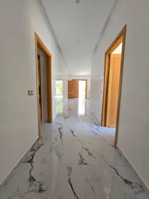 an empty room with marble floors and white walls at Villa echwitter in Marrakech