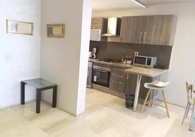 a small kitchen with a counter and a microwave at Skyline Studios Hivernage in Marrakech