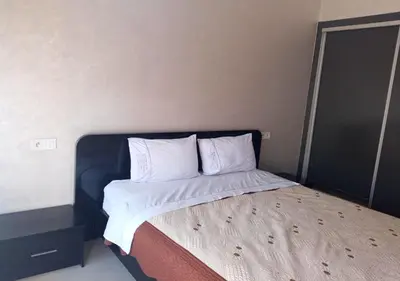 a bed with white sheets and pillows in a room at Skyline Studios Hivernage in Marrakech