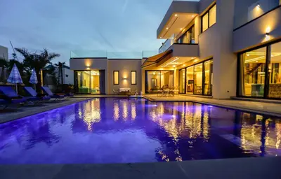 a swimming pool in a house with purple lighting at villa éden marrakech in Oulad Ikhia