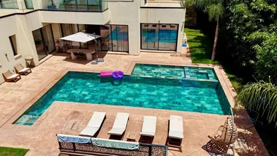 an overhead view of a swimming pool with chairs and a house at villa éden marrakech in Oulad Ikhia