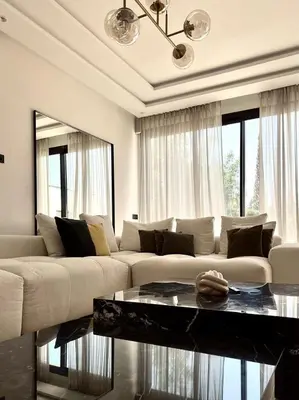 a living room with a white couch and a table at villa éden marrakech in Oulad Ikhia