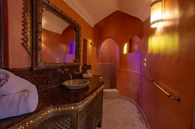 a bathroom with a sink and a mirror at Villa Ferme de Coco in El Caïd Omar