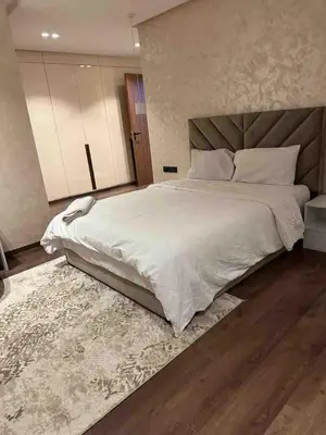 a bedroom with a large white bed and a rug at Villa in Urban Morocco, Marrakech in Marrakech