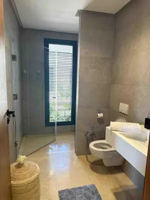 a bathroom with a toilet and a sink and a window at Villa in Urban Morocco, Marrakech in Marrakech