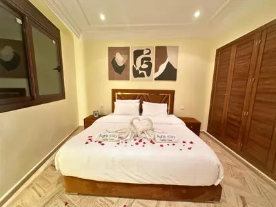 a bedroom with a bed with roses on it at Somptueux Appartement avec Jacuzzi Privé Marrakech in Marrakech