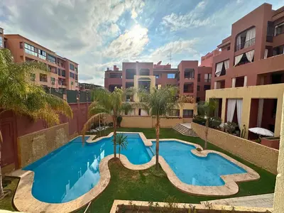an apartment with a swimming pool in a city at Somptueux Appartement avec Jacuzzi Privé Marrakech in Marrakech