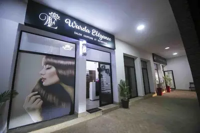 a building with a sign for a hair salon at Marrakech River Palm in Dar Caïd Layadi