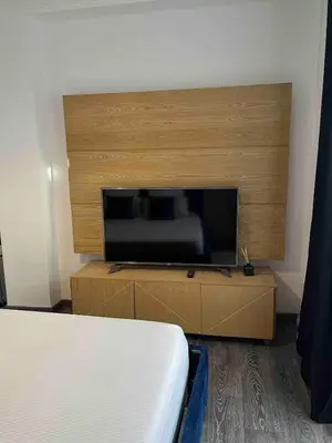 a bedroom with a large flat screen tv at Marrakech River Palm in Dar Caïd Layadi