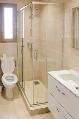 a bathroom with a shower with a toilet and a sink at Luxury 2BD in Prestigia Jade with Pool and Golf View in Marrakech