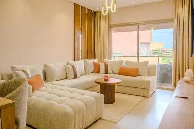a living room with a couch and a table at Luxury 2BD in Prestigia Jade with Pool and Golf View in Marrakech