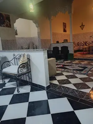 a room with a bench with a hat on it at big house with swiming pool in Marrakech