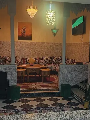 a living room with a couch and a table at big house with swiming pool in Marrakech
