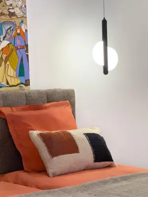 a couch with an orange pillow and a lamp at Villa à Marrakech 8 Personnes, Piscine et Petits-Déjeuners Inclus in Sraghna