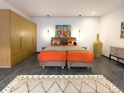 a bedroom with a large bed with an orange bedspread at Villa à Marrakech 8 Personnes, Piscine et Petits-Déjeuners Inclus in Sraghna