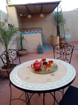 a table with pots and pans on a patio at Quite riad in Marrakech