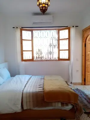a bedroom with a bed and a window at Quite riad in Marrakech