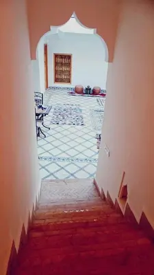 an entrance to a room with a tile floor and a hallway at Quite riad in Marrakech