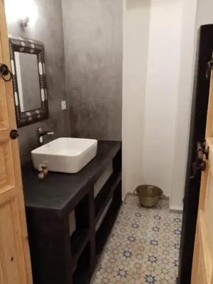 a bathroom with a white sink and a mirror at Quite riad in Marrakech