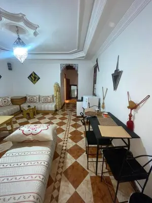 a living room with a table and a couch at Suite 1 in Marrakech