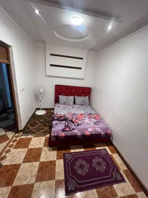a bedroom with a bed in the corner of a room at Suite 1 in Marrakech