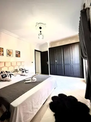 a large bedroom with two beds with black cabinets at Marrakech in Marrakech