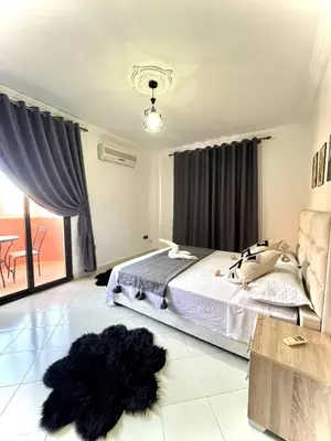 a bedroom with a bed and a black dog laying on the floor at Marrakech in Marrakech