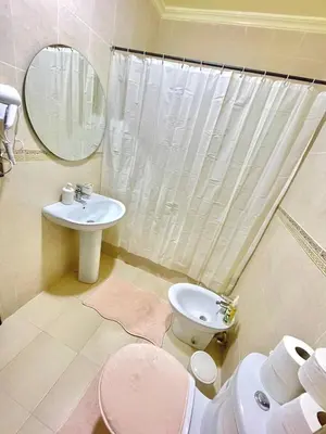 a bathroom with a sink and a toilet and a mirror at Marrakech in Marrakech