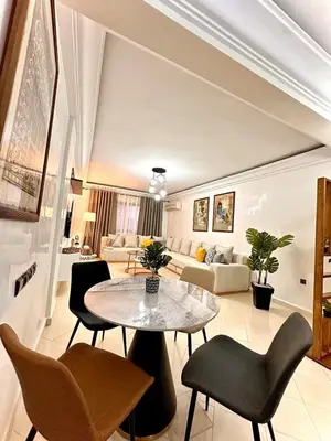 a living room with a table and chairs at Marrakech in Marrakech