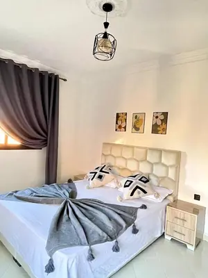 a bedroom with two beds and a chandelier at Marrakech in Marrakech