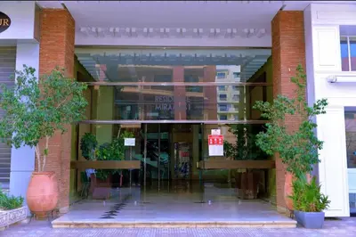 a building with a glass entrance with trees in front at Modern Studio with Pool in Central Gueliz in Marrakech