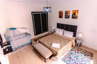 a bedroom with a large bed and a rug at Modern Studio with Pool in Central Gueliz in Marrakech