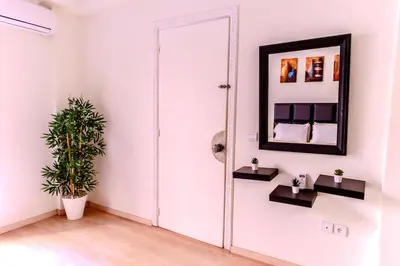 a mirror in a white room with a plant at Modern Studio with Pool in Central Gueliz in Marrakech