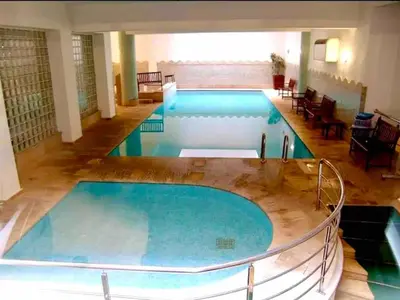 a large swimming pool in a building at Modern Studio with Pool in Central Gueliz in Marrakech