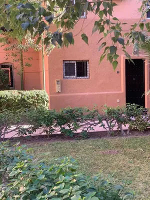 a pink building with a window and a door at Maison Mariam in Marrakech