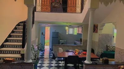 a living room with a staircase and a table at Maison Mariam in Marrakech